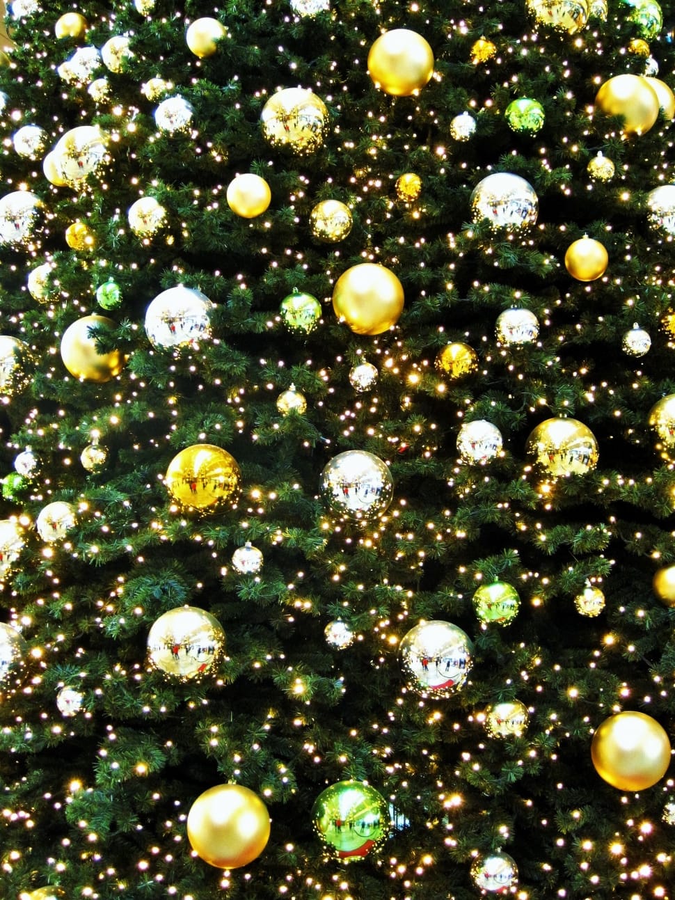 green christmas tree with baubles and christmas lights preview