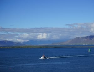 motor boat on blue sea during daytime thumbnail