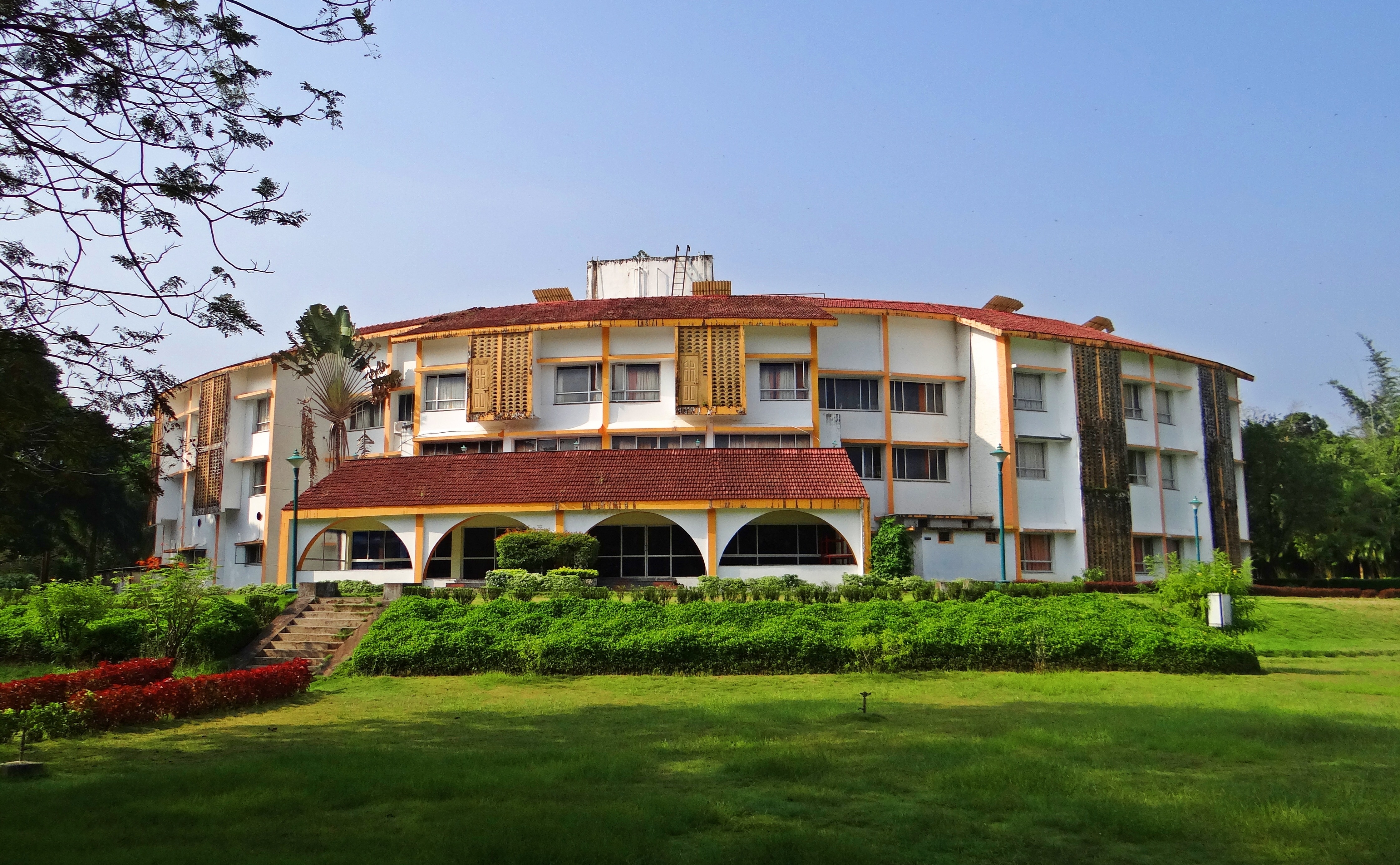 white and brown building near green grasses