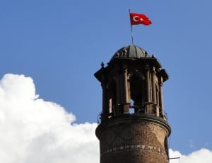 turkey flag on brown tower during daytime thumbnail