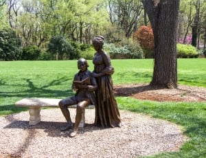 brown couple statue on bench thumbnail