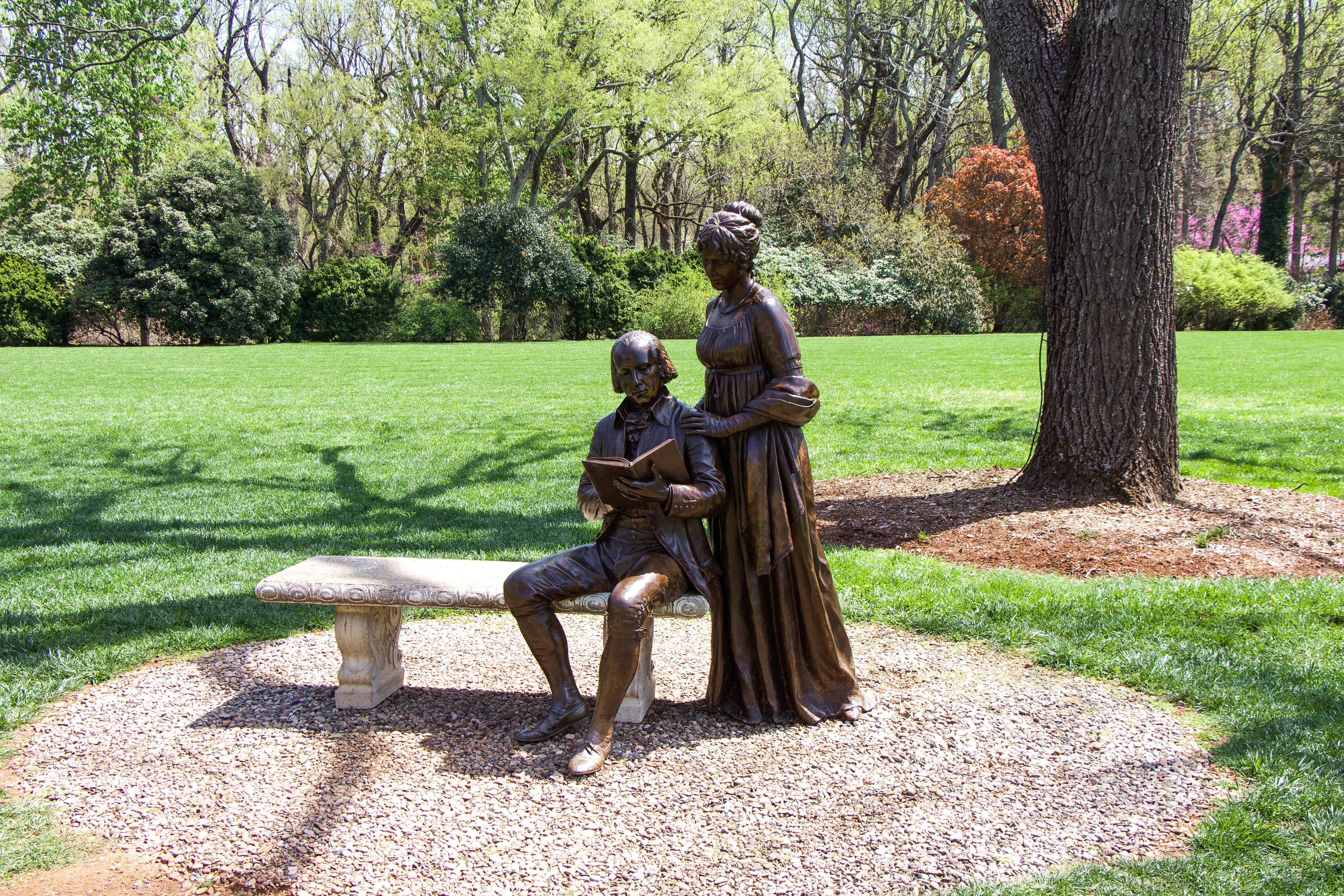 brown couple statue on bench