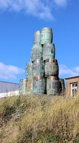grey wooden barrels under blue sky during daytime thumbnail