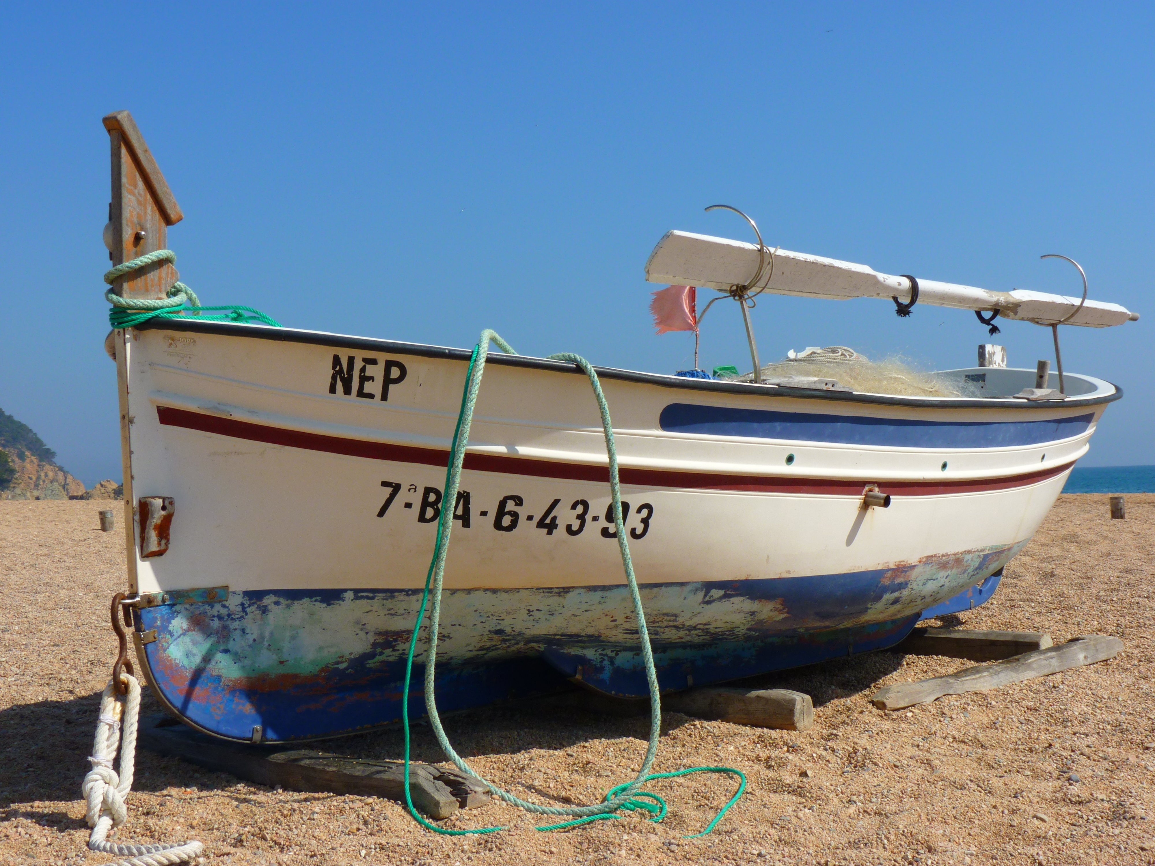 white and blue nep fishing boat