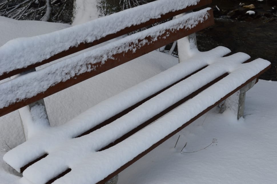 snow covered wooden bench preview