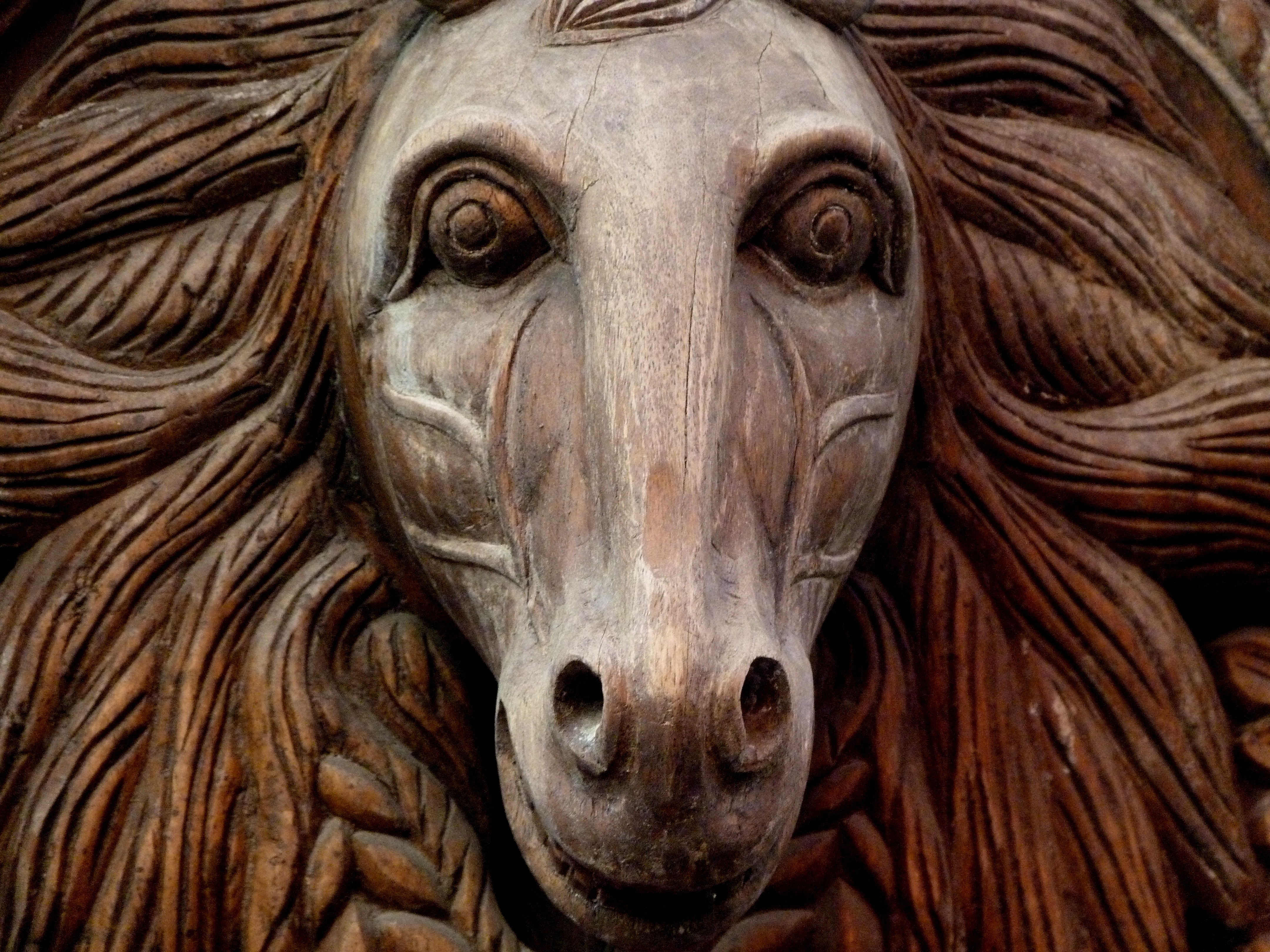 brown wooden horse head figurine
