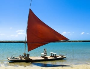 brown and red sail boat thumbnail