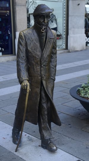 man holding cane statue thumbnail
