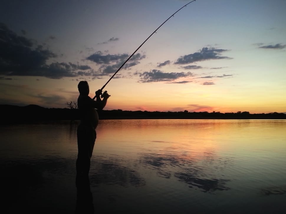 silhouette photography on man fishing preview