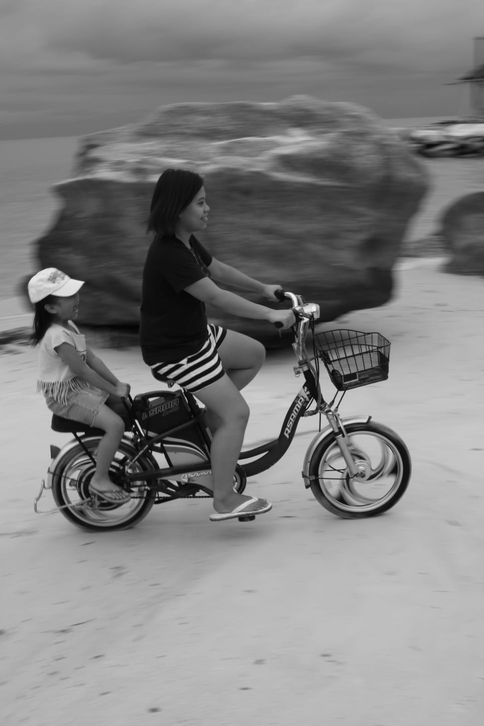 gray scale photo of 2 girls riding tandem bike preview