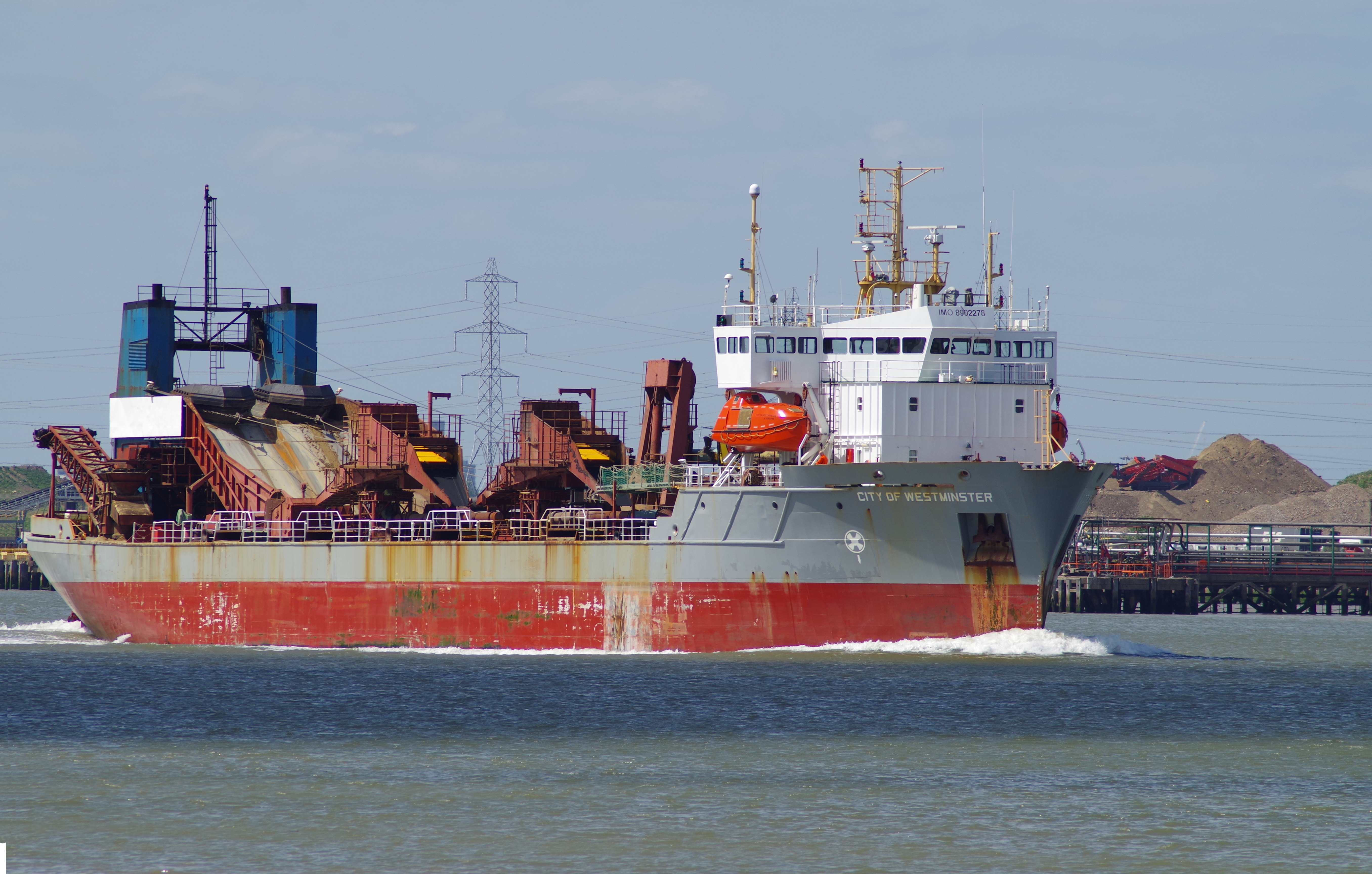 grey and red cargo ship