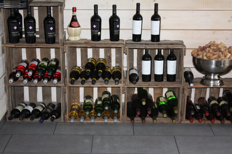 wine bottles on brown wooden crate shelves preview