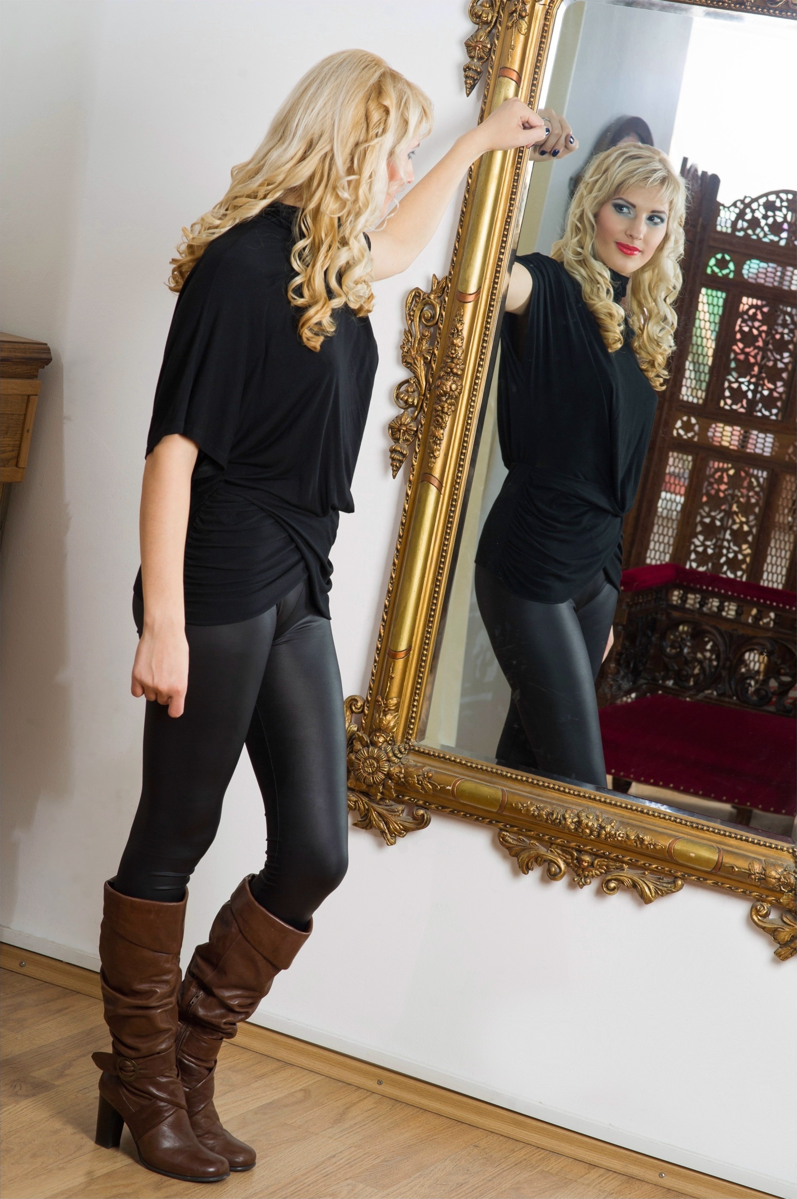 women's black blouse and brown leather heeled knee high boots outfit
