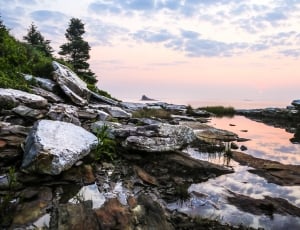 landscape photgraphy of rocks on body of water thumbnail