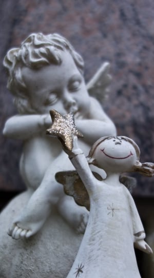gold and white girl holding star figurine thumbnail