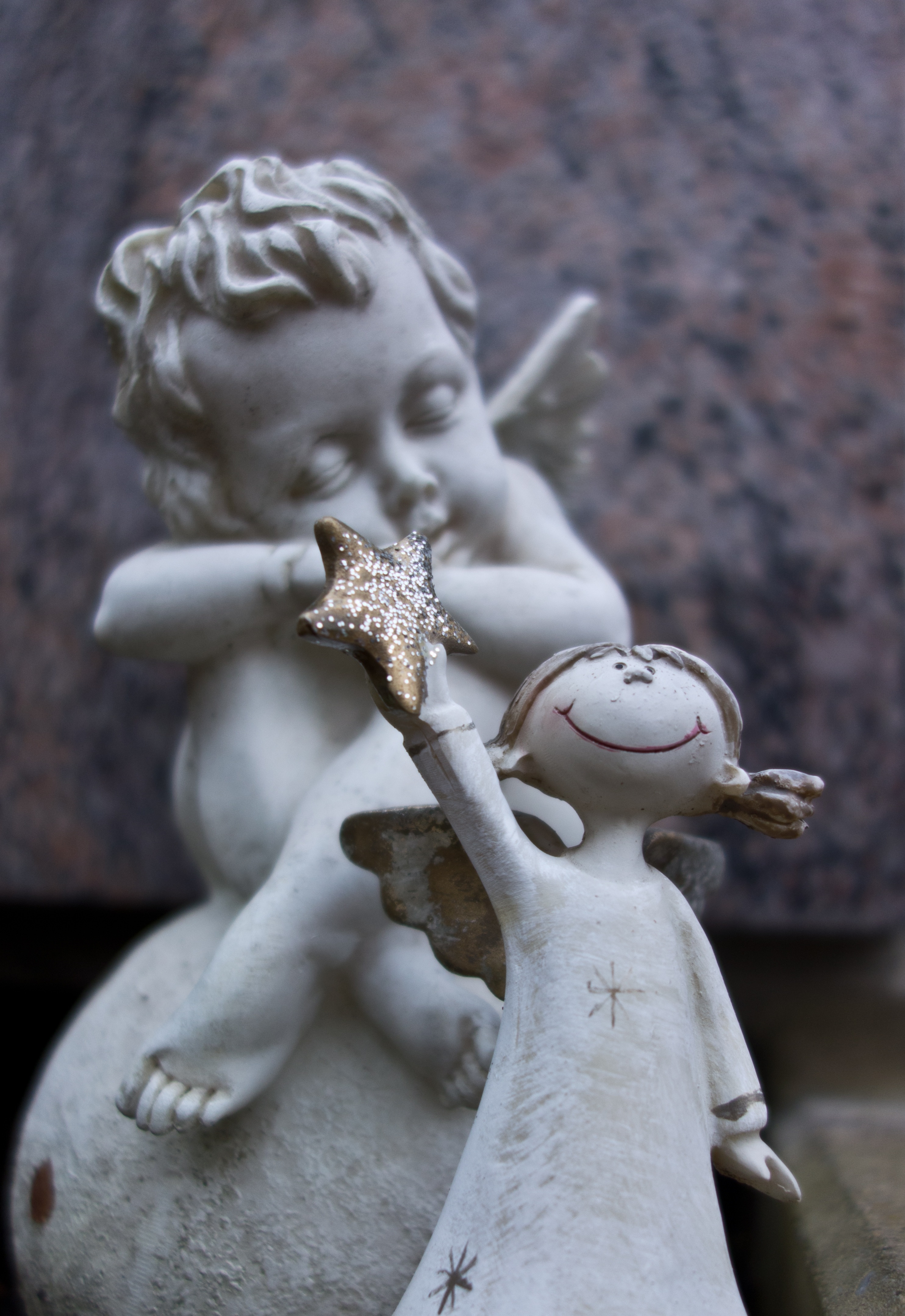 gold and white girl holding star figurine