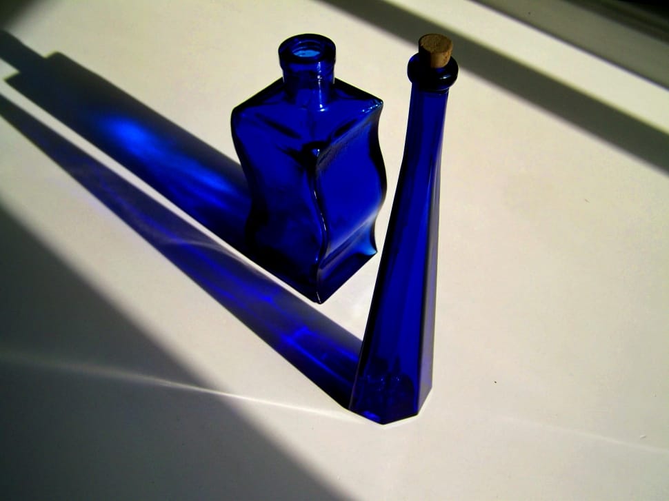 two blue tinted glass bottles preview
