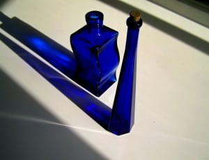two blue tinted glass bottles thumbnail