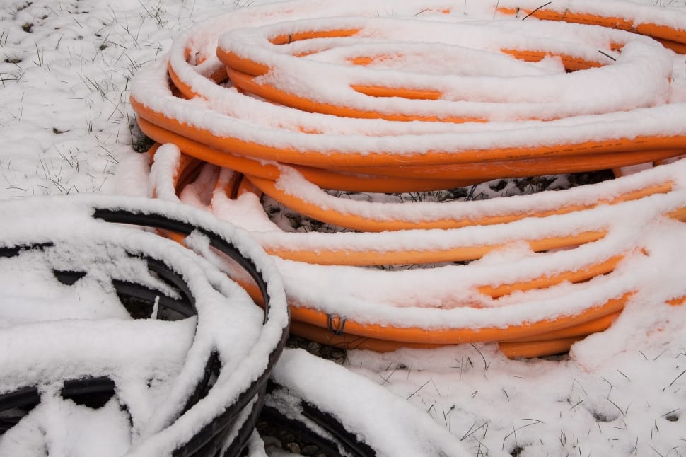 orange plastic tube covered with snow preview