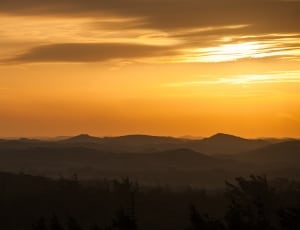 silhouette photo of mountains during sunset thumbnail