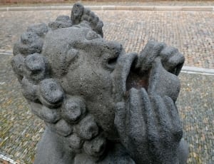 man holding his mouth statue thumbnail