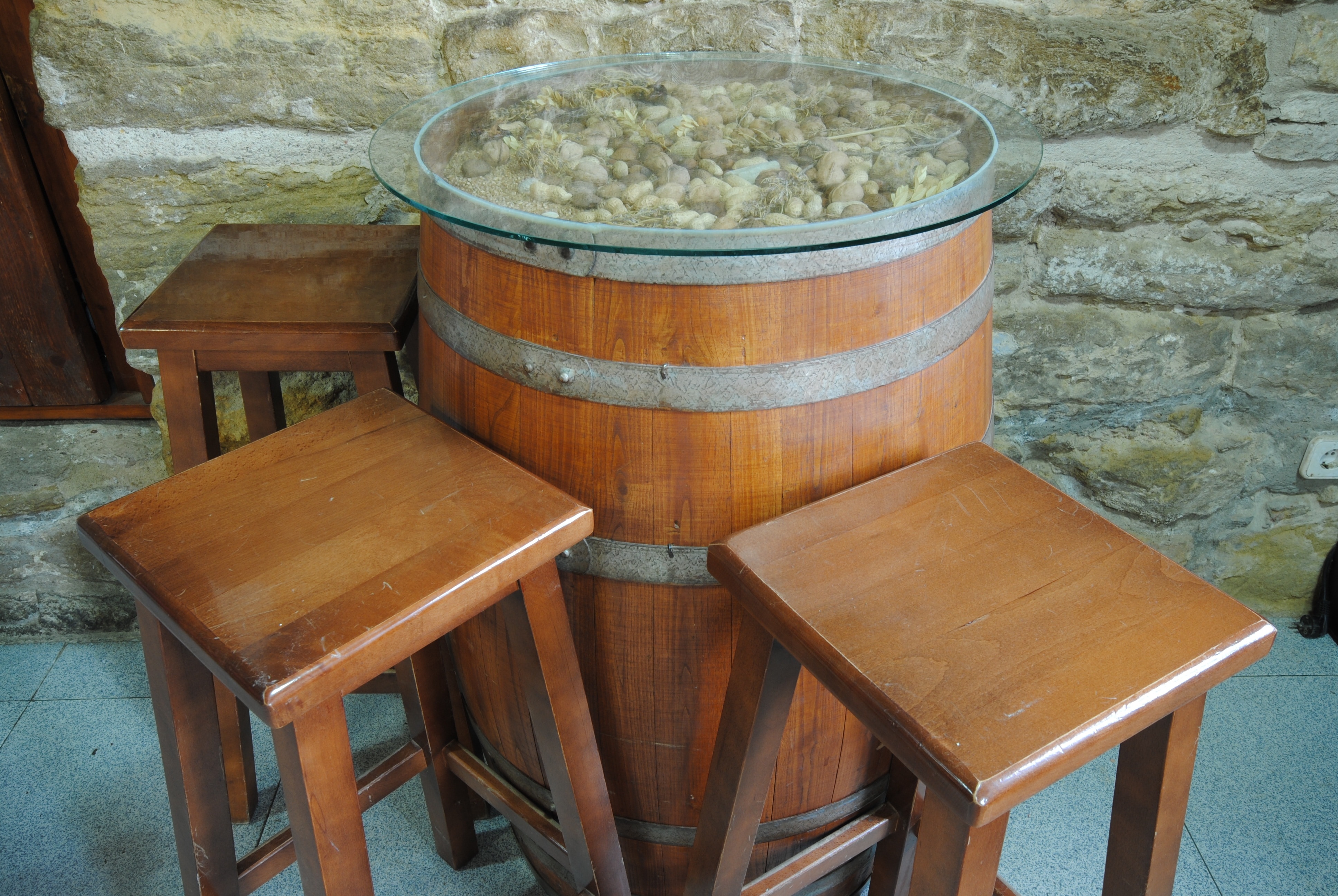 brown wooden barrel clear glass top table