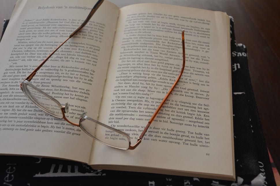 brown eyeglasses and book preview