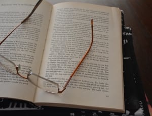 brown eyeglasses and book thumbnail