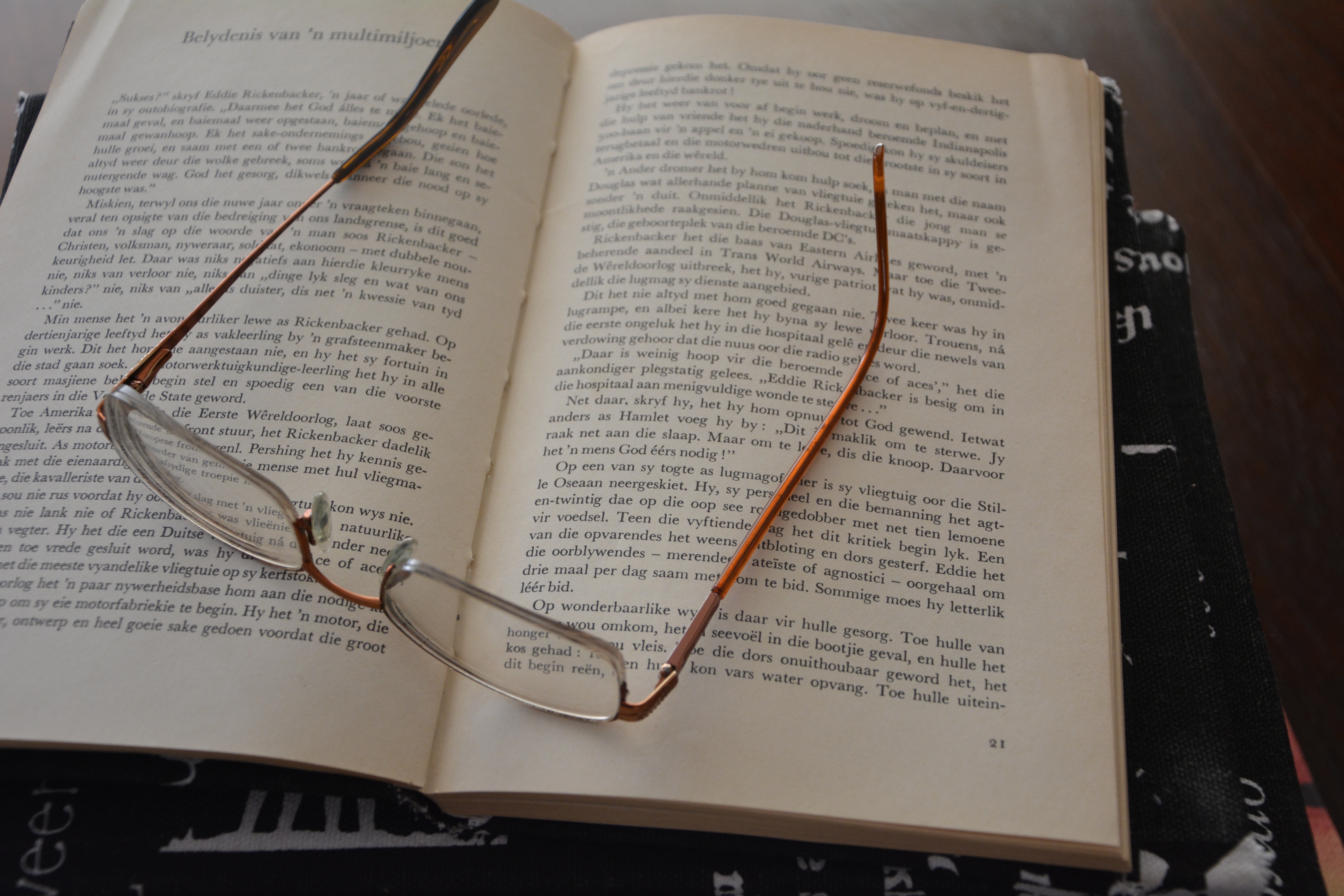 brown eyeglasses and book