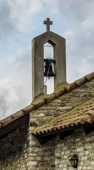 church bell under cloudy sky during daytime thumbnail