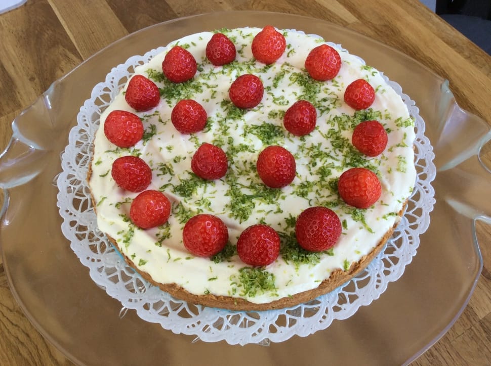 white coated cake with strawberry toppings preview
