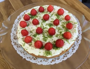 white coated cake with strawberry toppings thumbnail