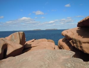 brown rock formation near at sea water thumbnail