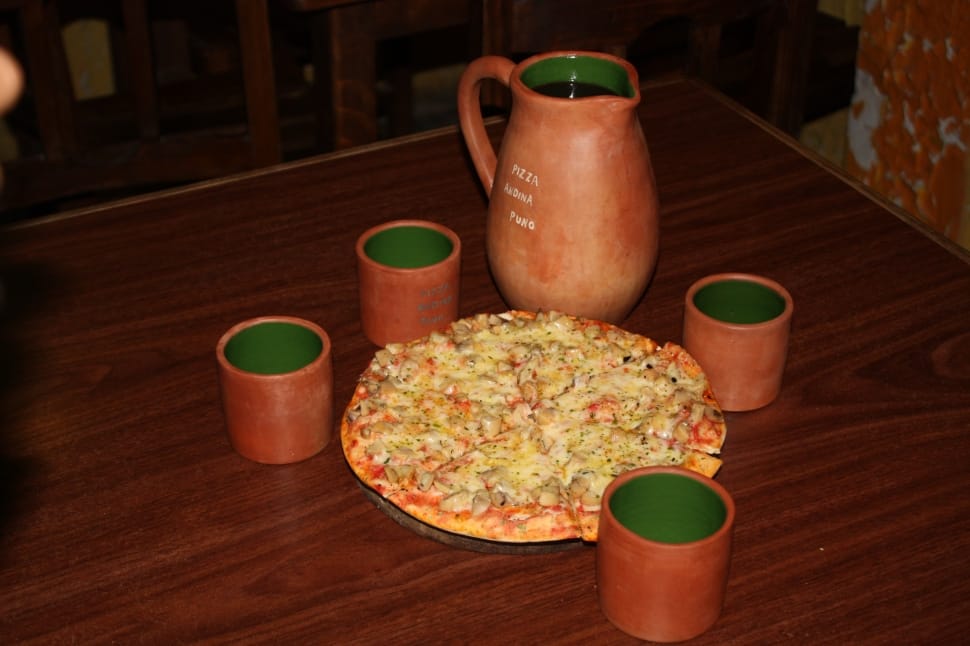 brown ceramic pitcher and drinking glasses and pizza preview