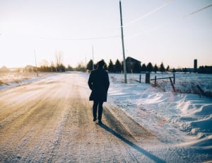 silhouette of person walking on the road thumbnail