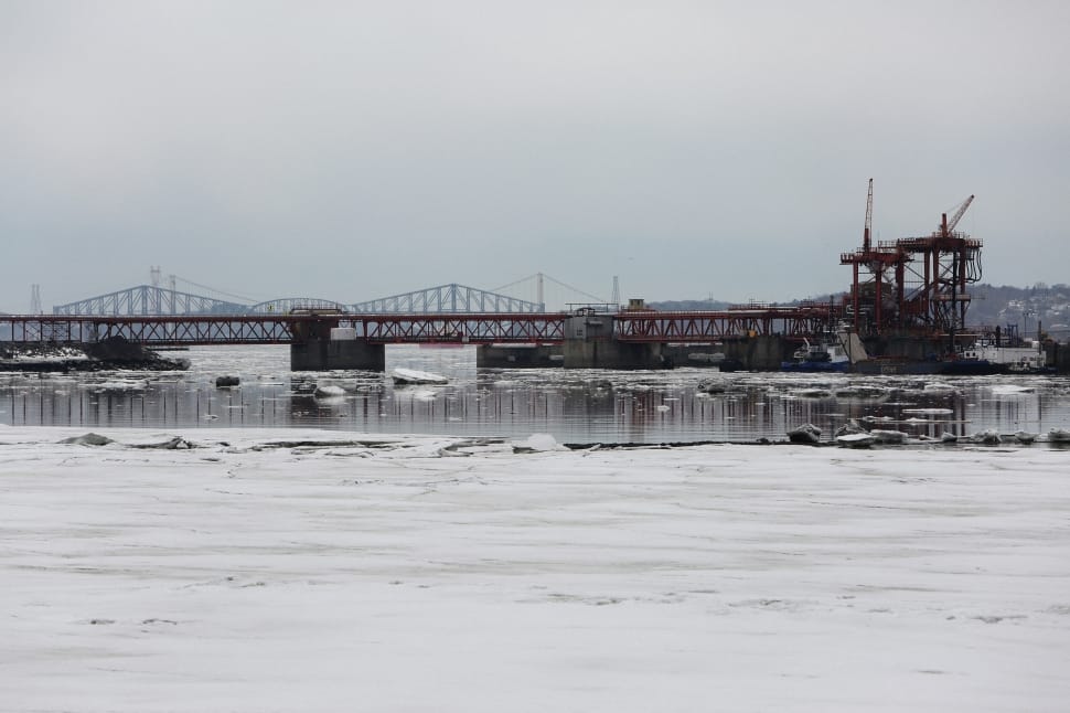 architectural shot of bridge on snowy body of water preview