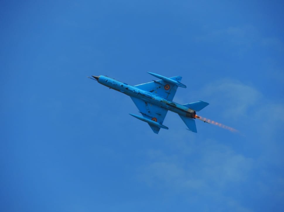 blue jet plate taking flight at sky during daytime preview