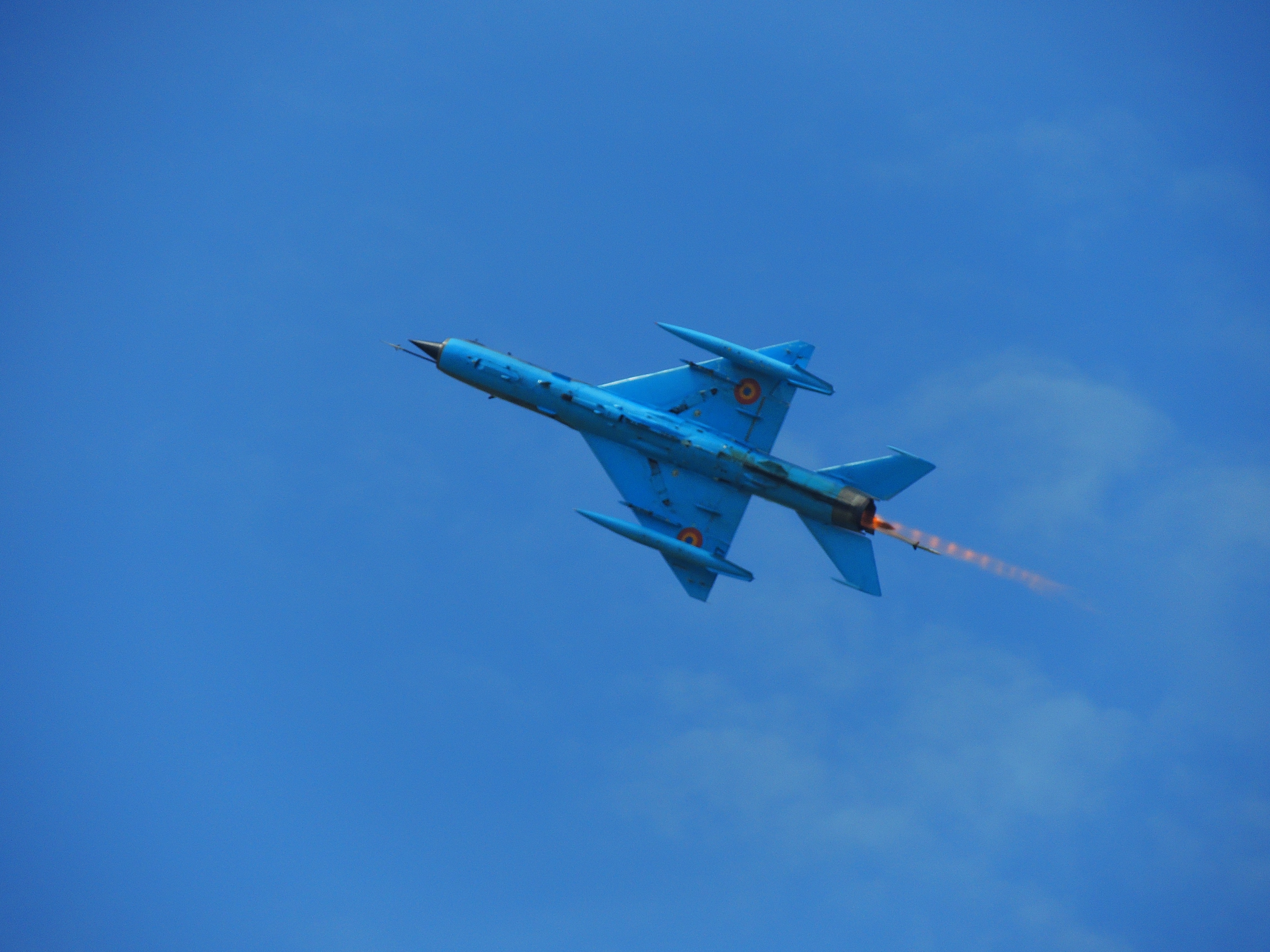 blue jet plate taking flight at sky during daytime