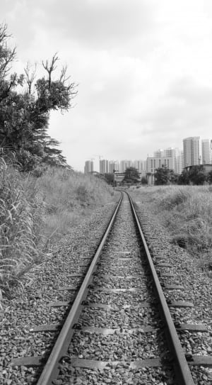 grayscale photo of train rail thumbnail