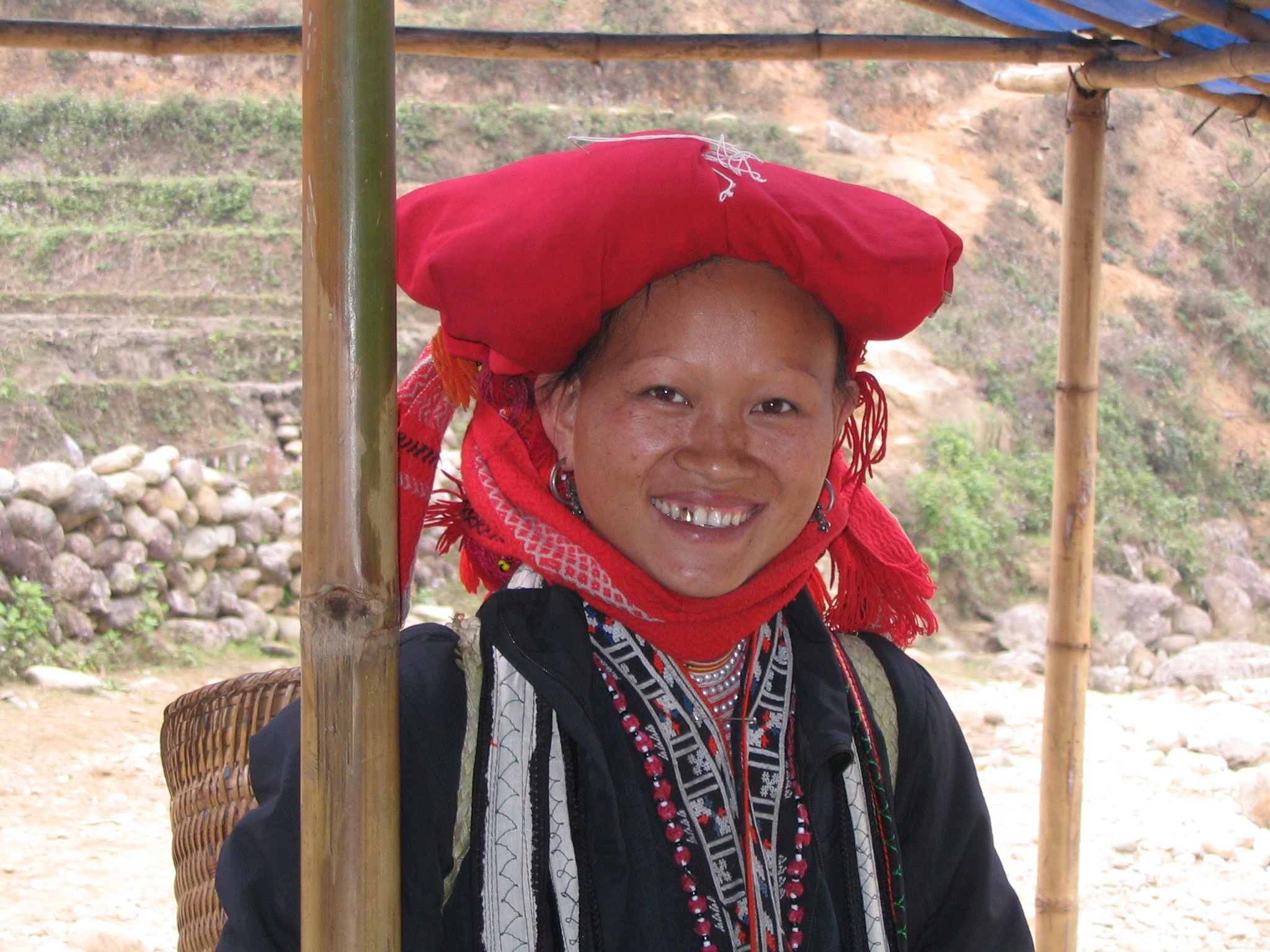 woman in black and red grey tribal clothing smiling