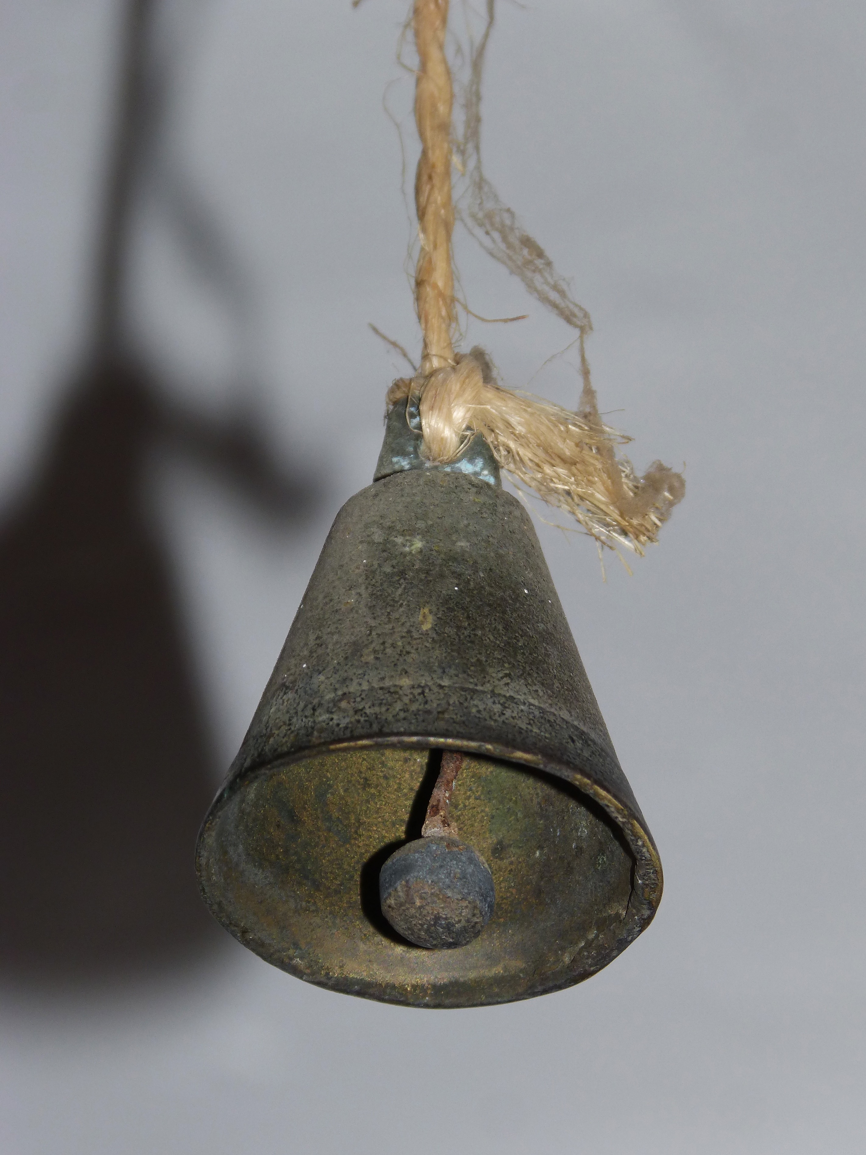black bell with brown rope
