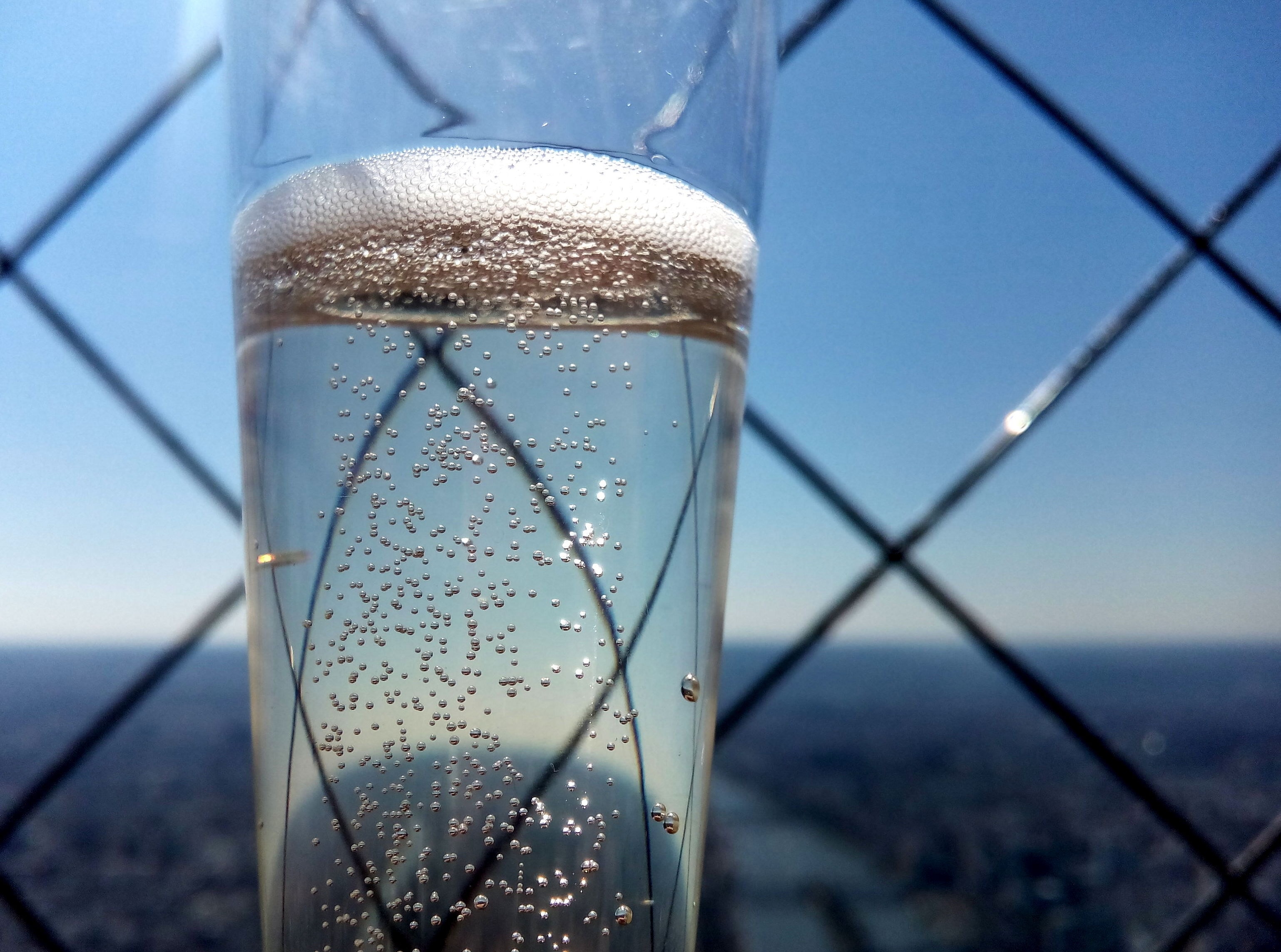 clear liquid in clear glass bottle