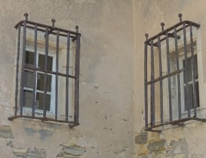 two windows with black metal grills thumbnail