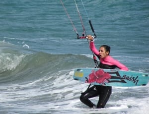 woman in pink and black wet suit thumbnail