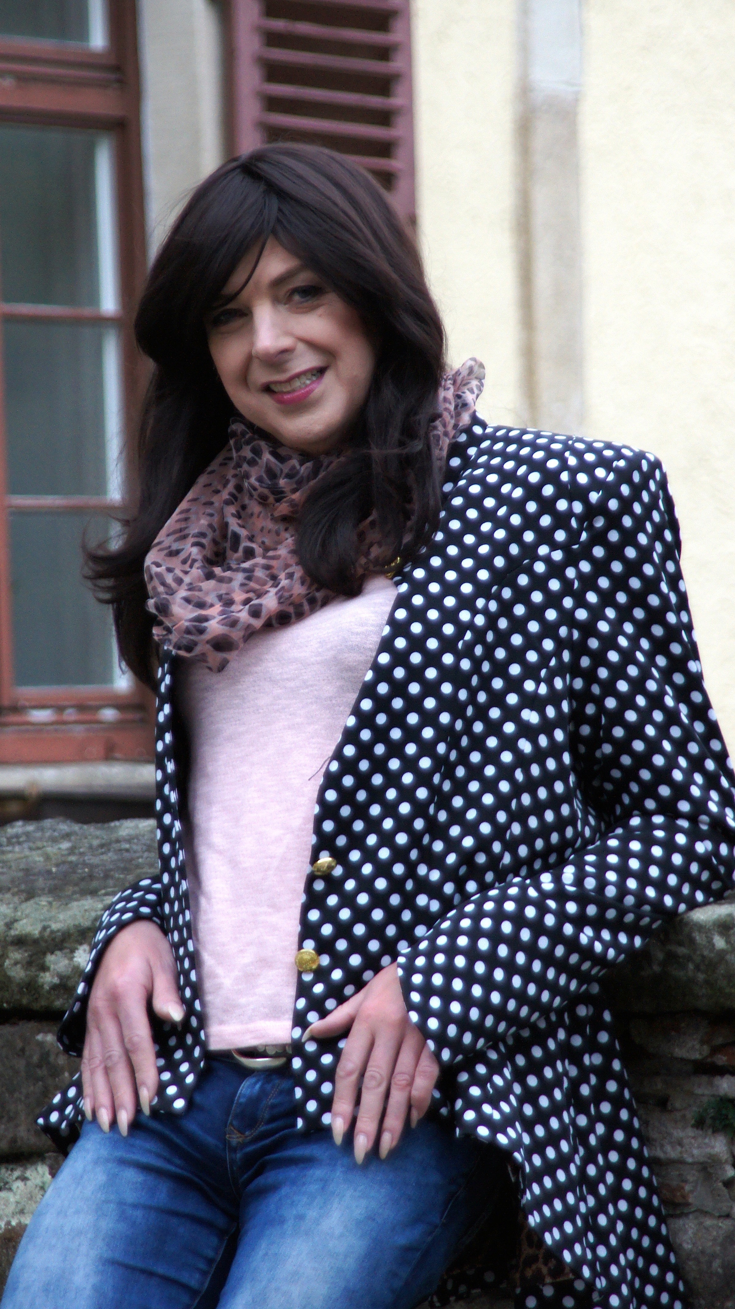 women's black and white polka dot blazer, blue denim jeans and brown scarf