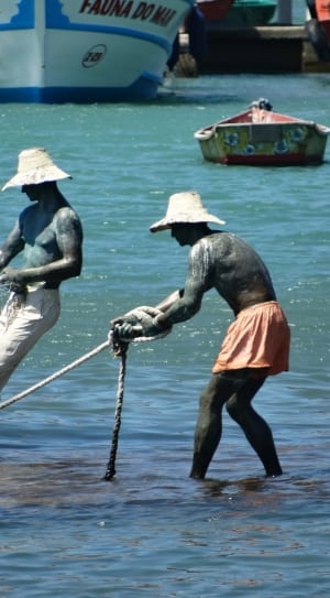 two men pulling a rope near the shore thumbnail
