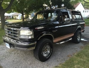 black Ford Bronco parked near brown tree thumbnail