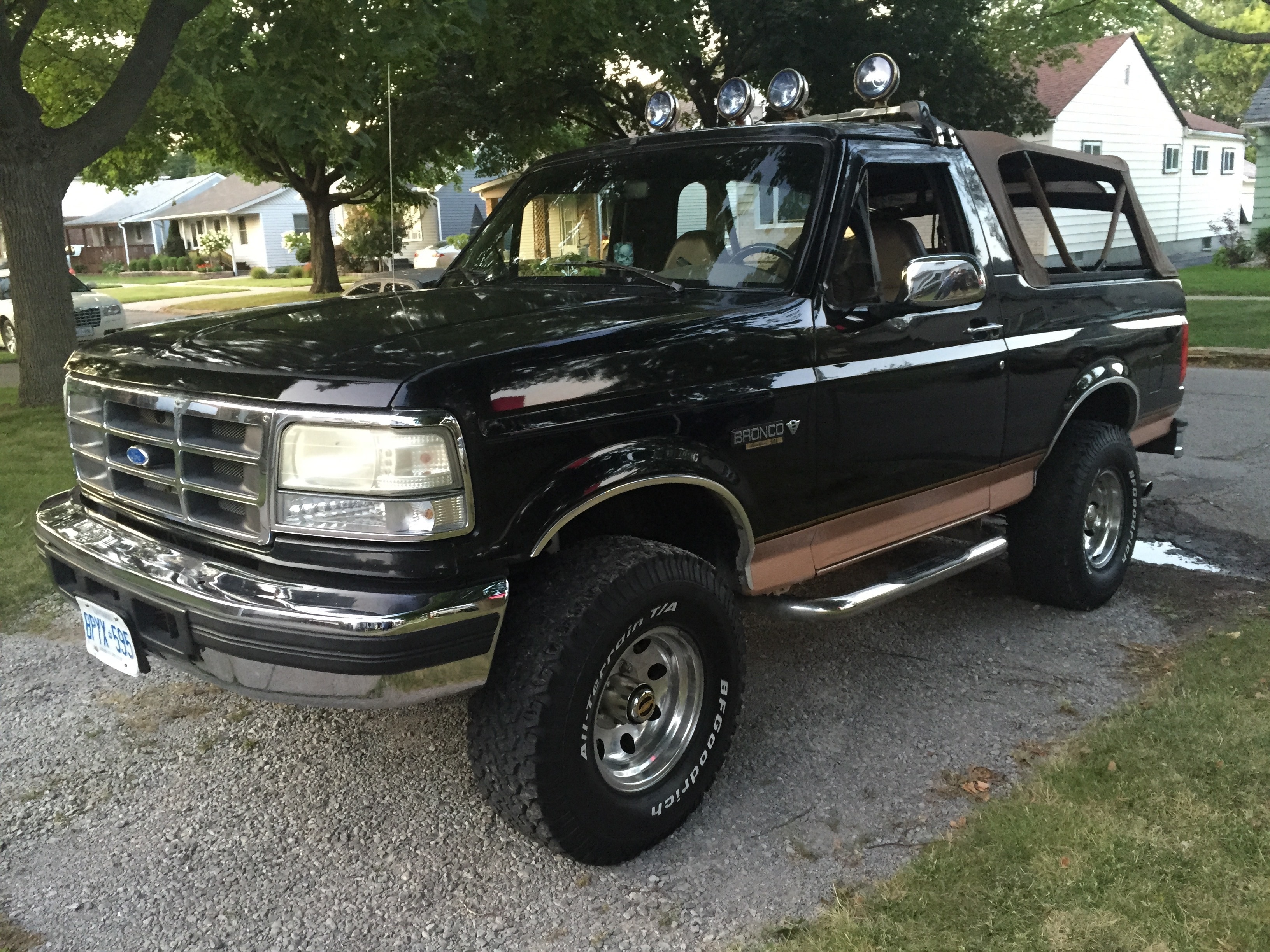 black Ford Bronco parked near brown tree