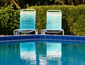 2 blue and white pool side chairs thumbnail