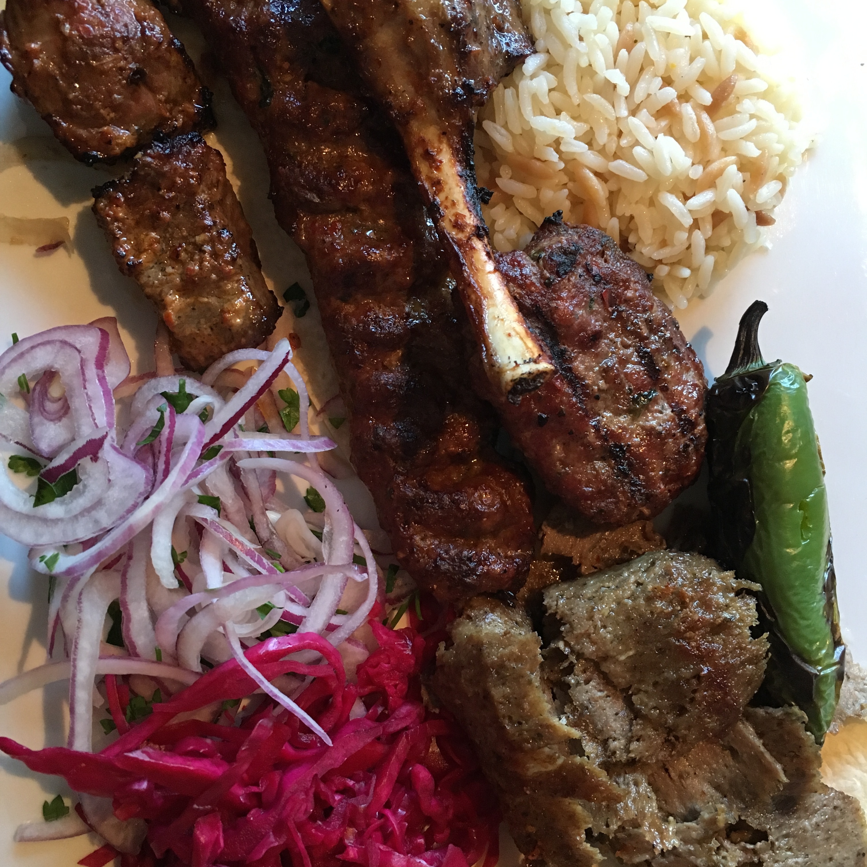 grilled meat with rice and slice red onions